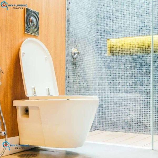 A professional plumber in Miyapur installs wall-mounted commodes with secure fittings, concealed tanks, and proper alignment for modern bathroom designs and space saving.